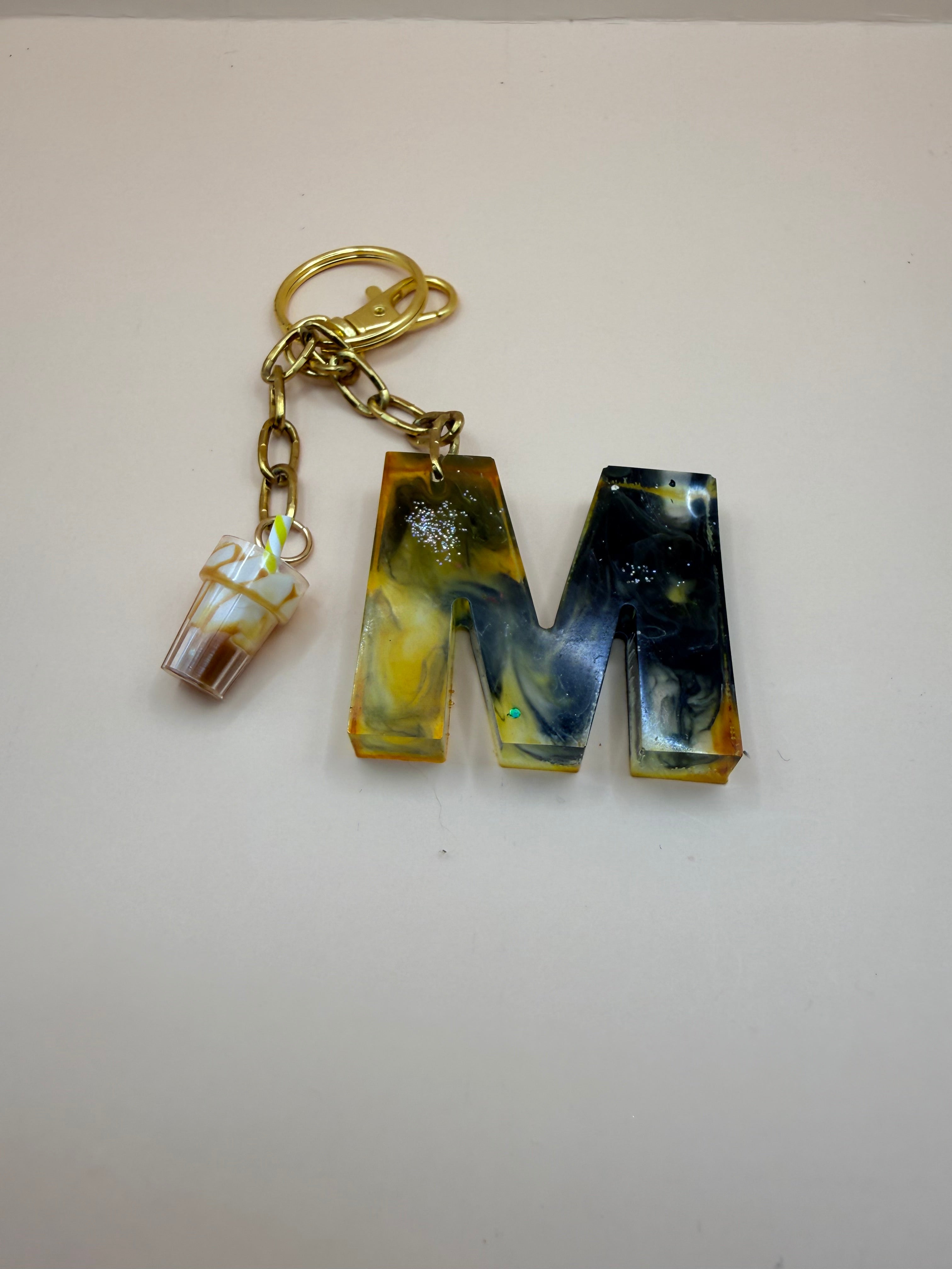 gepersonaliseerde sleutelhanger met een letter en bedeltje